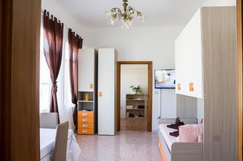 a small room with a bed and a chandelier at Forte apartments "Enjoy Salento" in Avetrana