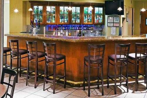 a bar with stools in a restaurant at Radisson Hotel El Paso Airport in El Paso