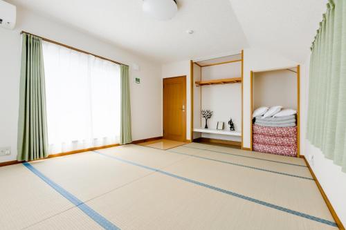an empty room with a carpet on the floor at PLUS 9 Station INN in Izumi-Sano