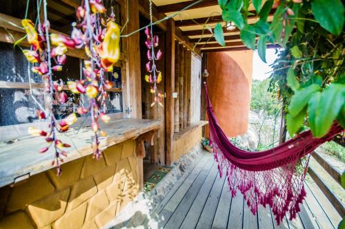 a hammock hanging from a porch of a building at Bio Chalé Carrancas in Carrancas