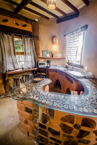 a large living room with a large fireplace in the center at Bio Chalé Carrancas in Carrancas