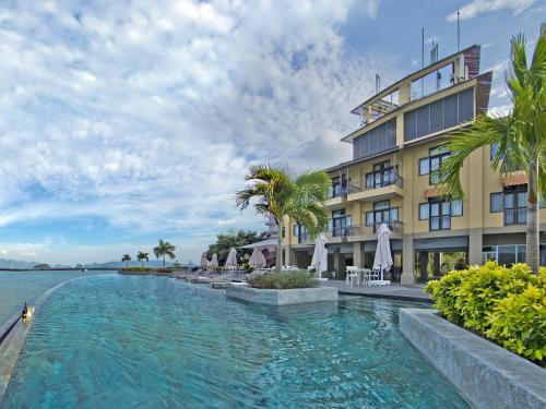 a swimming pool in front of a building at Resorts World Langkawi in Pantai Cenang