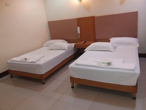 A bed or beds in a room at Asia Novo Boutique Hotel - Catbalogan