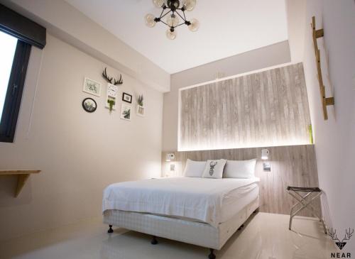 a bedroom with a white bed and a window at NEAR B&b 2283 in Hualien City