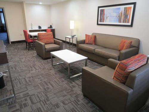 a living room with couches and a table and a tableablish at Holiday Inn Brookfield - Milwaukee by IHG in Brookfield