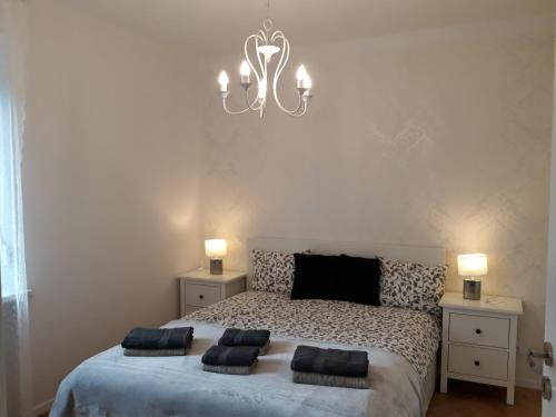 a bedroom with a bed with two pillows on it at 2 Bedroom City Center Apartment in Katowice