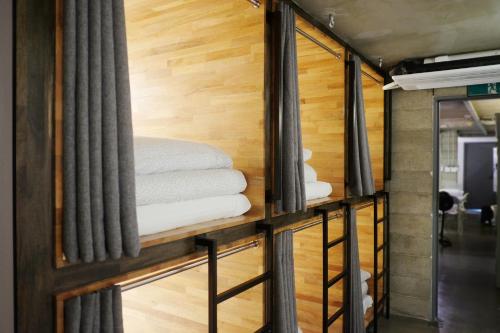 a room with columns and towels on a shelf at The Cube Hotel in Seoul