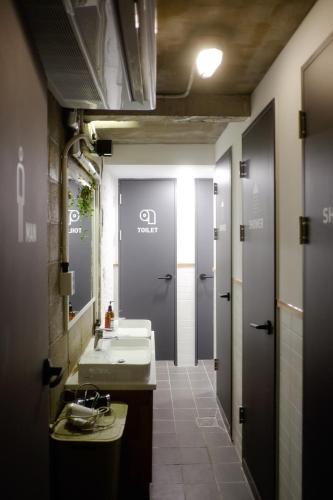 a bathroom with a sink and a mirror at The Cube Hotel in Seoul