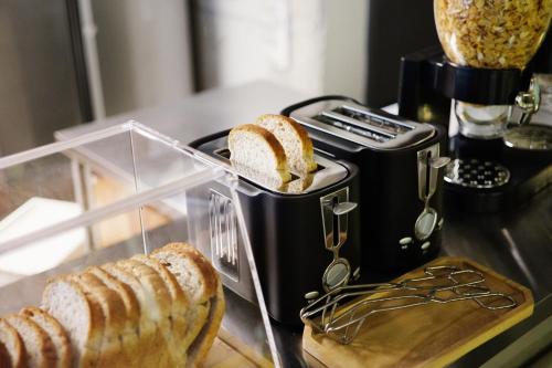 a loaf of bread in a container next to a toaster at The Cube Hotel in Seoul