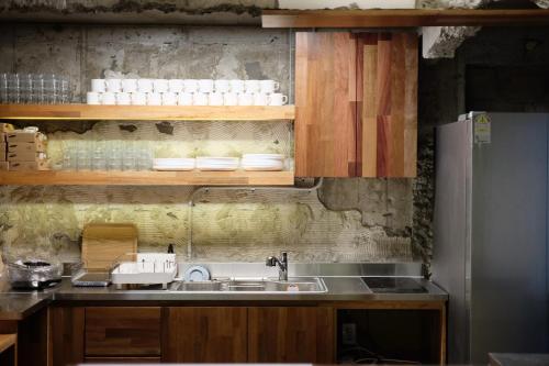 a kitchen with a sink and a refrigerator at The Cube Hotel in Seoul