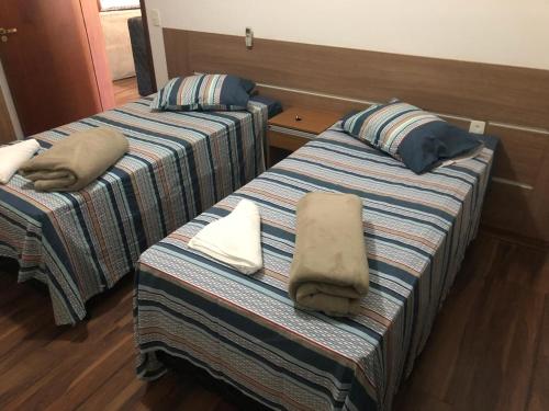 A bed or beds in a room at Hospedagem Oliveira Vaz Lobo