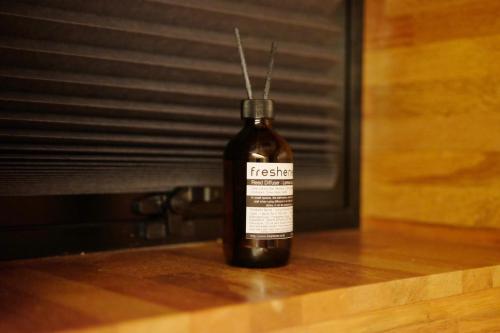 a bottle of wine sitting on a wooden table at The Cube Hotel in Seoul