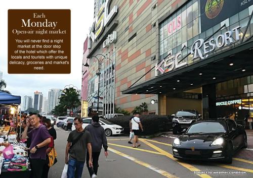a group of people walking down a street in front of a market at KSL Hotel & Resort in Johor Bahru