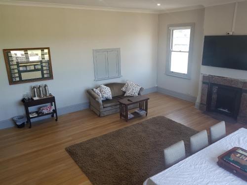 a living room with a couch and a fireplace at Helensburgh Hotel in Helensburgh