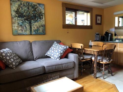 a living room with a couch and a table at Sawing Logzz Cabin in Copper Center