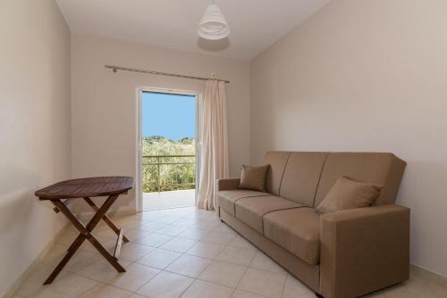 a living room with a couch and a table at Allegro Studios & Apartments in Marathias