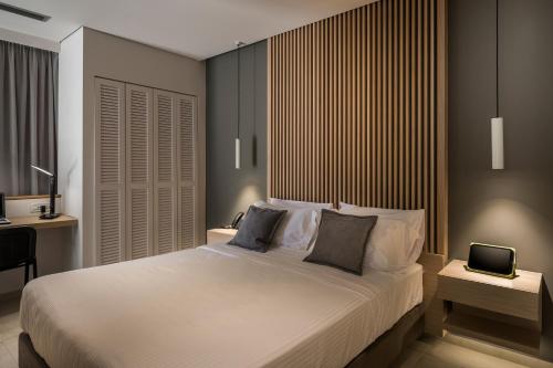 a bedroom with a bed with a laptop on it at Trianon Luxury Apartments & Suites in Chania Town
