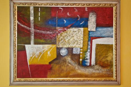 a painting in a frame on a wall at Hotel Villa Rosa in Sirmione