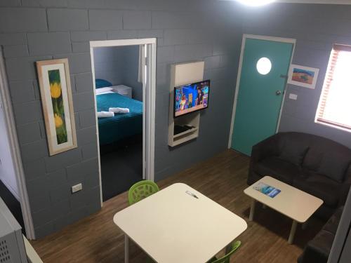 a small living room with a couch and a mirror at Esperance Central Apartments in Esperance
