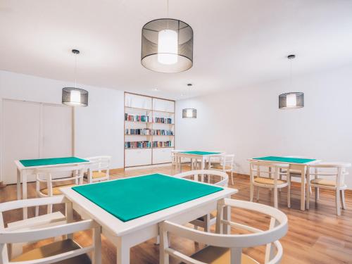a room with tables and chairs and a book shelf at Iberostar Waves Las Dalias All Inclusive in Adeje