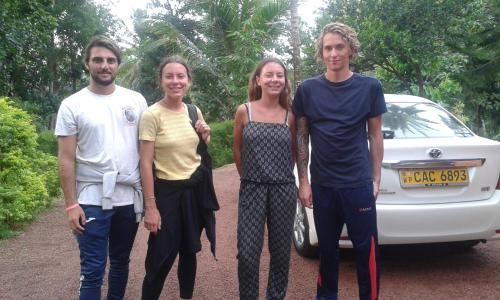 a group of people standing in front of a car at Sunset Villa in Negombo