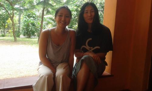 two women are sitting on a window sill at Sunset Villa in Negombo
