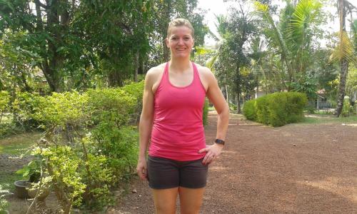 a woman in a pink tank top standing in a park at Sunset Villa in Negombo