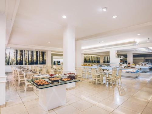 a restaurant with tables and chairs and food on display at Iberostar Waves Las Dalias All Inclusive in Adeje
