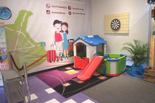 a childrens play room with a painting on the wall at favehotel Braga in Bandung