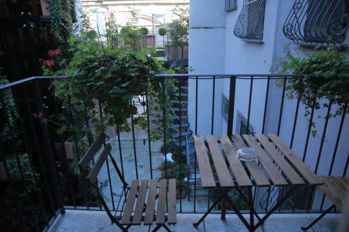 a wooden table and two chairs on a balcony at La Canonica - charming self-catering apartments in Nizza Monferrato in Nizza Monferrato