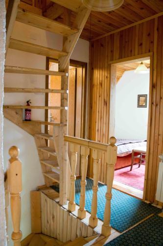 a wooden staircase in a house with a room at Villa Moutain View in Žabljak