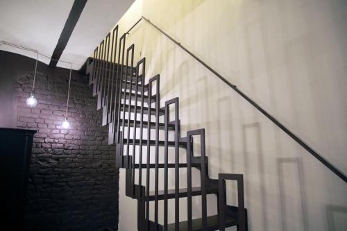 a staircase in a room with a brick wall at La Canonica - charming self-catering apartments in Nizza Monferrato in Nizza Monferrato