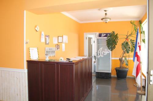 a court room with a desk and a refrigerator at Hotel Kavkasioni in Kvareli