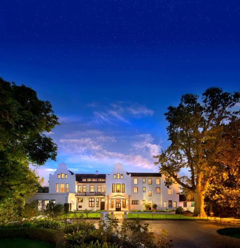 an exterior view of a building at night at The Cellars-Hohenort in Cape Town