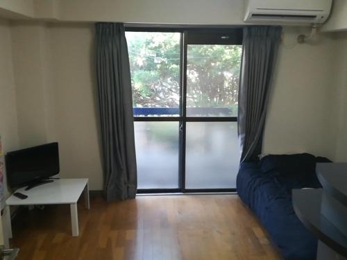 a bedroom with a bed and a large window at Yakuendai Wacore Elegance in Chiba