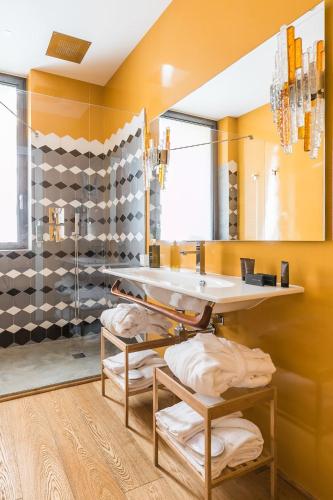 a bathroom with a sink and a shower at Rarity Suites in Rome