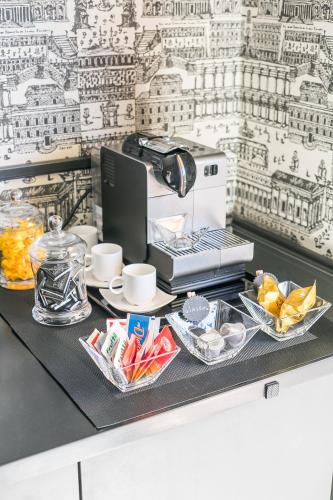 a black counter top with a coffee maker and food at Rarity Suites in Rome