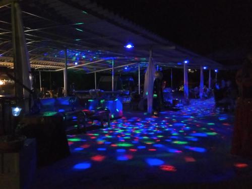 a party with blue and green lights on the floor at Anatoli Hotel in Agia Marina Aegina