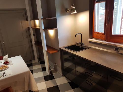 ジノーザ・マリーナにあるBnB Villa Sant'Angeloのチェッカー付きの床、シンク付きのキッチンが備わります。