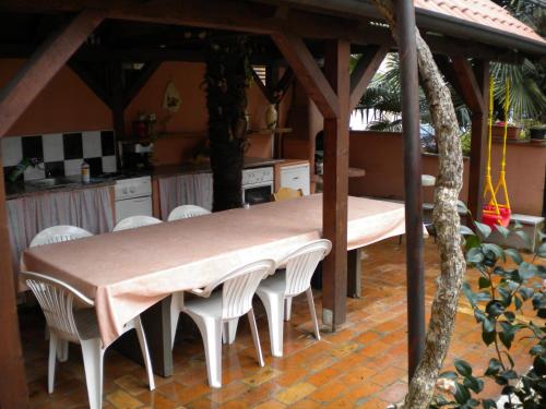 a table and chairs under a gazebo in a kitchen at Apartments Tajana in Novigrad Istria