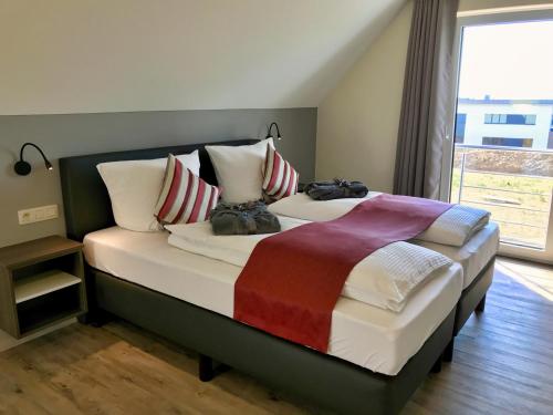 a bedroom with two beds and a large window at Villa Natica in Butgenbach