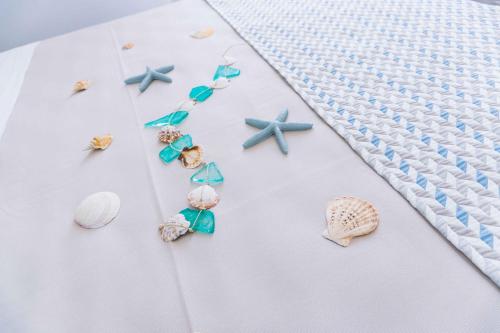 a white shirt with seashells and starfish at B&B Le Tartarughe in San Vito lo Capo