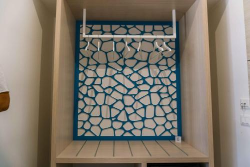 a walk in closet with a blue and white screen at B&B Le Tartarughe in San Vito lo Capo