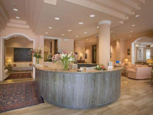 a lobby with a bar in a hotel at Hotel Settentrionale Esplanade in Montecatini Terme