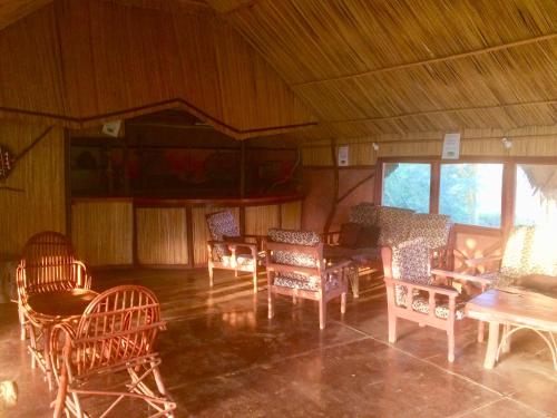 a room with chairs and tables in a building at Amboseli Eco Camp in Amboseli