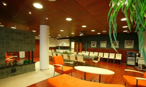 a dining room with tables and chairs in a restaurant at Santasport Resort in Rovaniemi