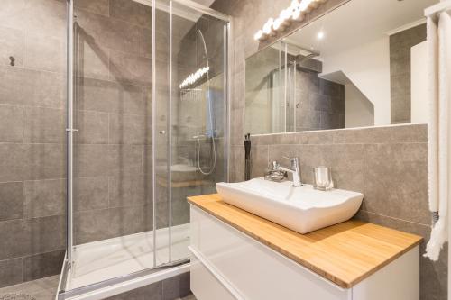 a bathroom with a sink and a shower at Bairrus Lisbon Apartments - Rossio in Lisbon