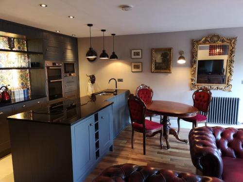 a kitchen with a table and a dining room at The Curate's Quarters at the Old Vicarage in Lincoln
