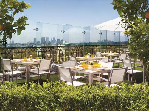 a row of tables and chairs on a patio at The London West Hollywood at Beverly Hills in Los Angeles