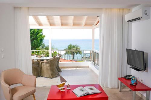 a living room with a view of the ocean at Acrotel Athena Villa in Elia